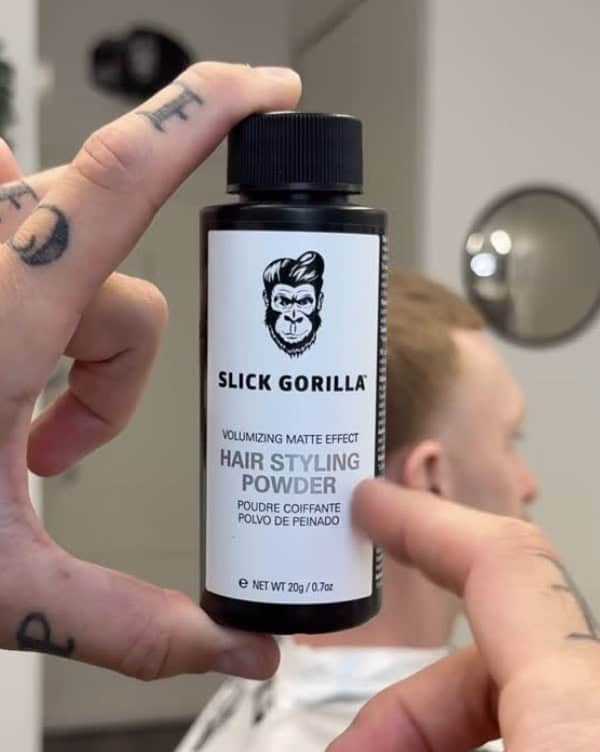 Holding a bottle of slick gorilla hair powder