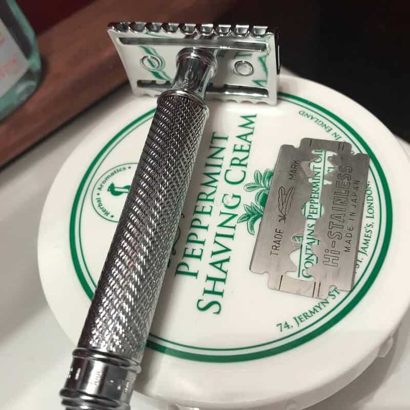 a safety razor on top of the taylor of old bond street shaving cream