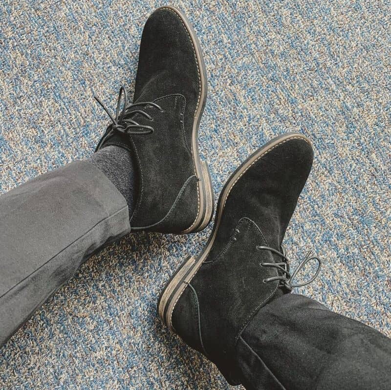 wearing a pair of black suede dress boots by bruno marc