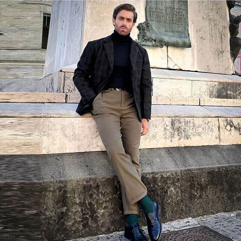 man wearing a checked blazer and khaki pants