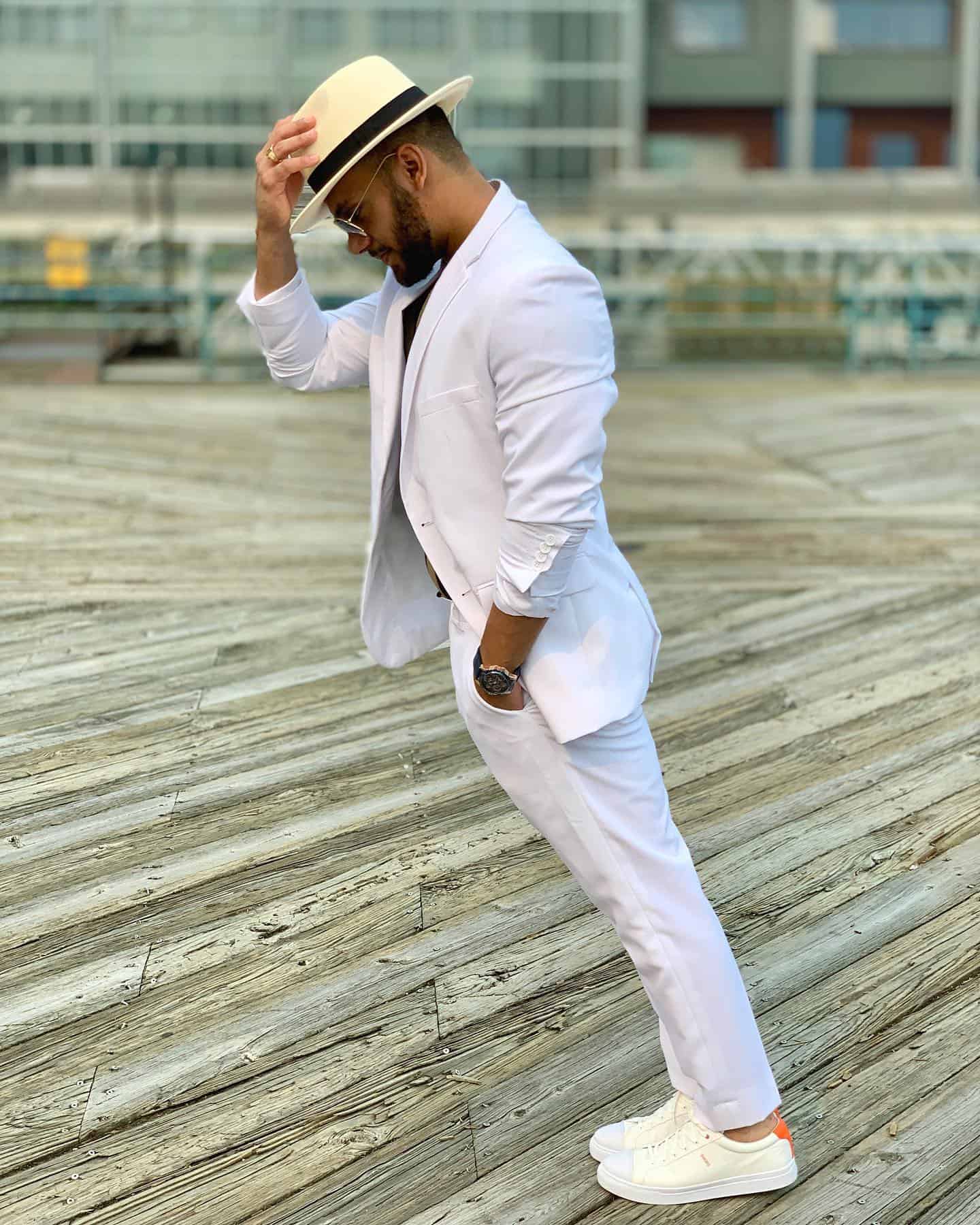 man in a white suit doing the smooth criminal lean move