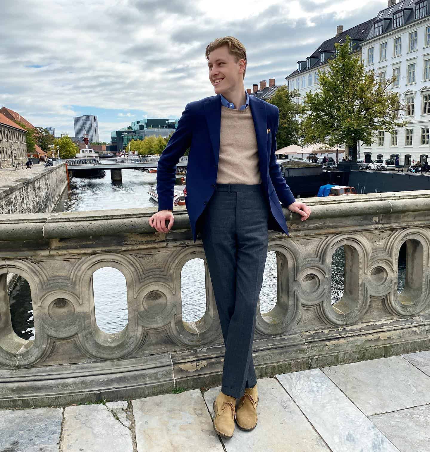 man standing on the bridge wearing a blue blazer