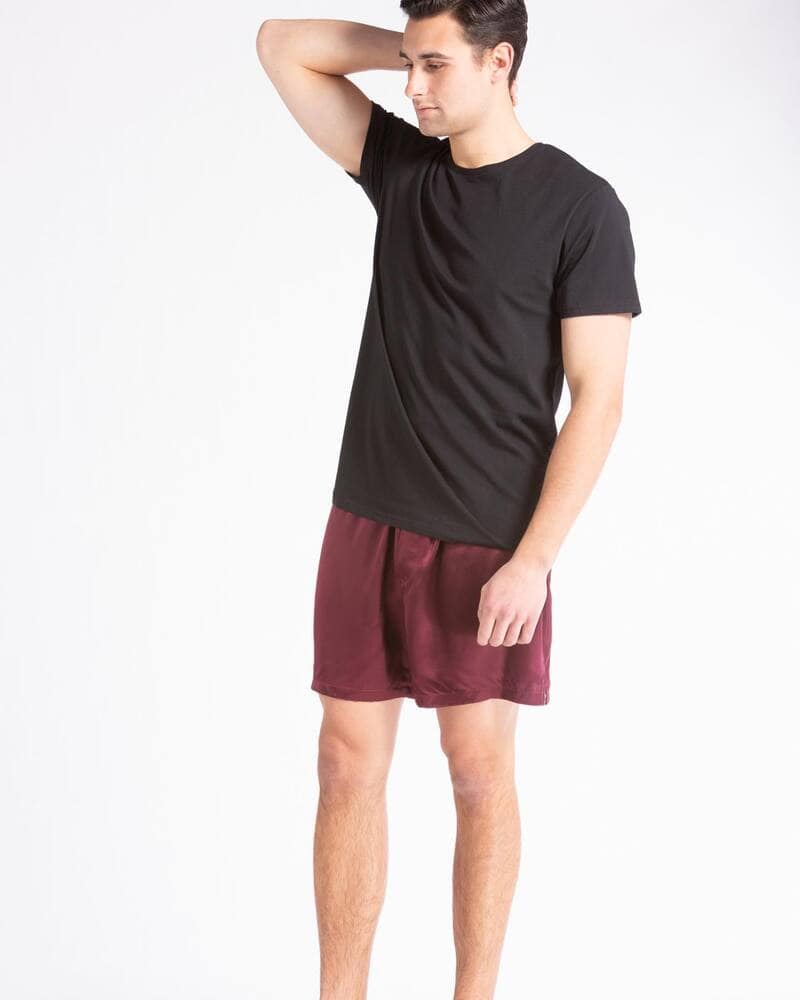 man wearing a black t-shirt and red satin boxers