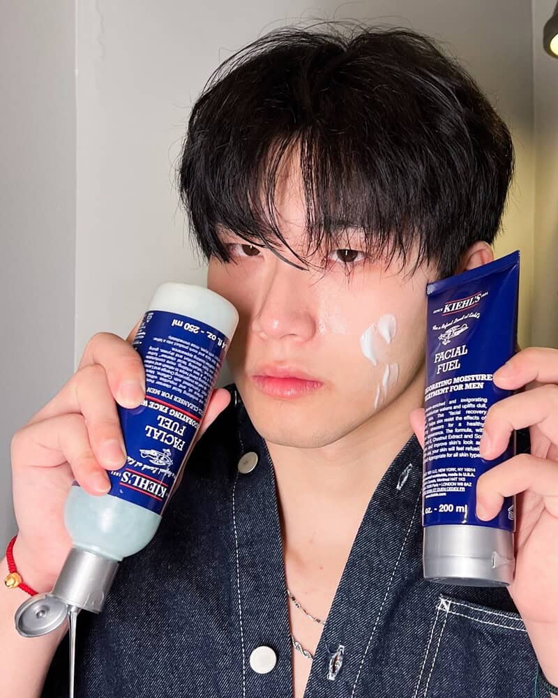 man holding the facial fuel face wash and facial moisturizer