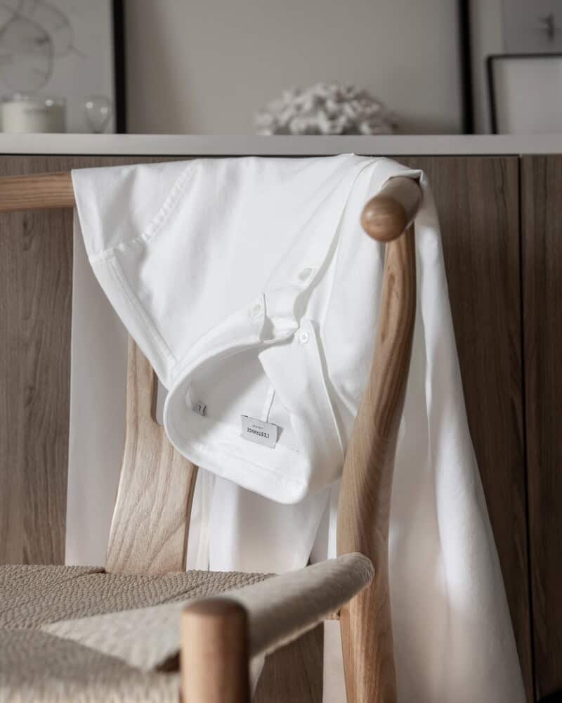 an oxford shirt by l'estrange hanging on a chair