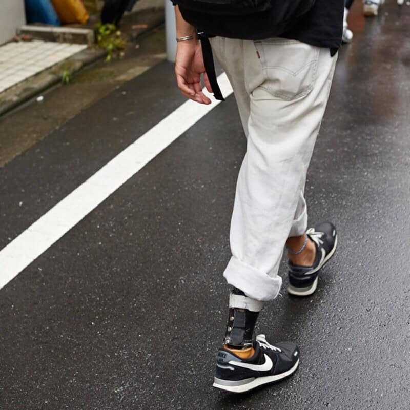 man wearing white jeans with hems folded high