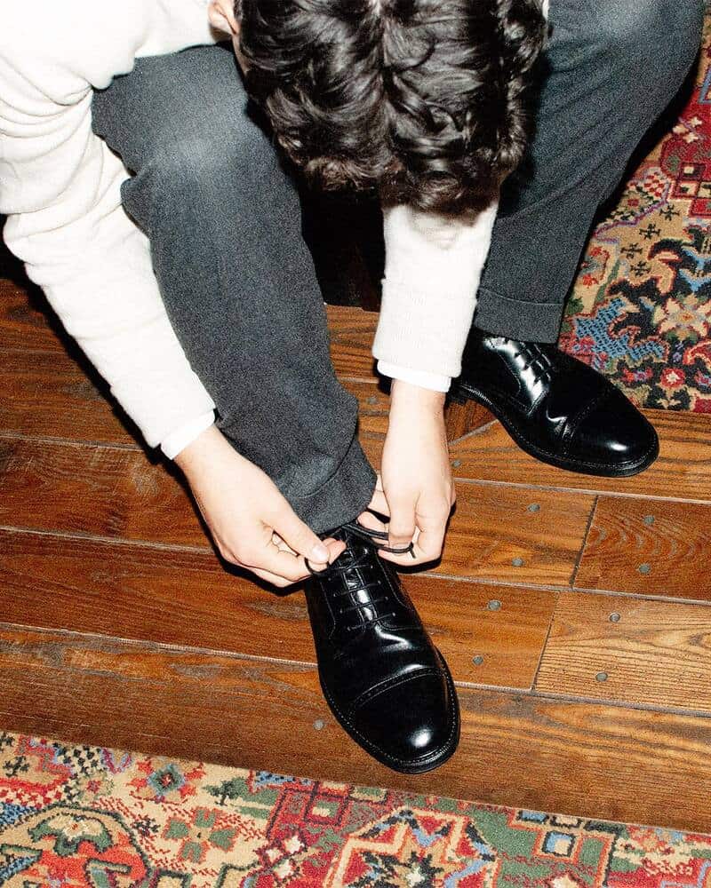 man tying a shoelace of a Tjarno Dress Boots by Myrqvist