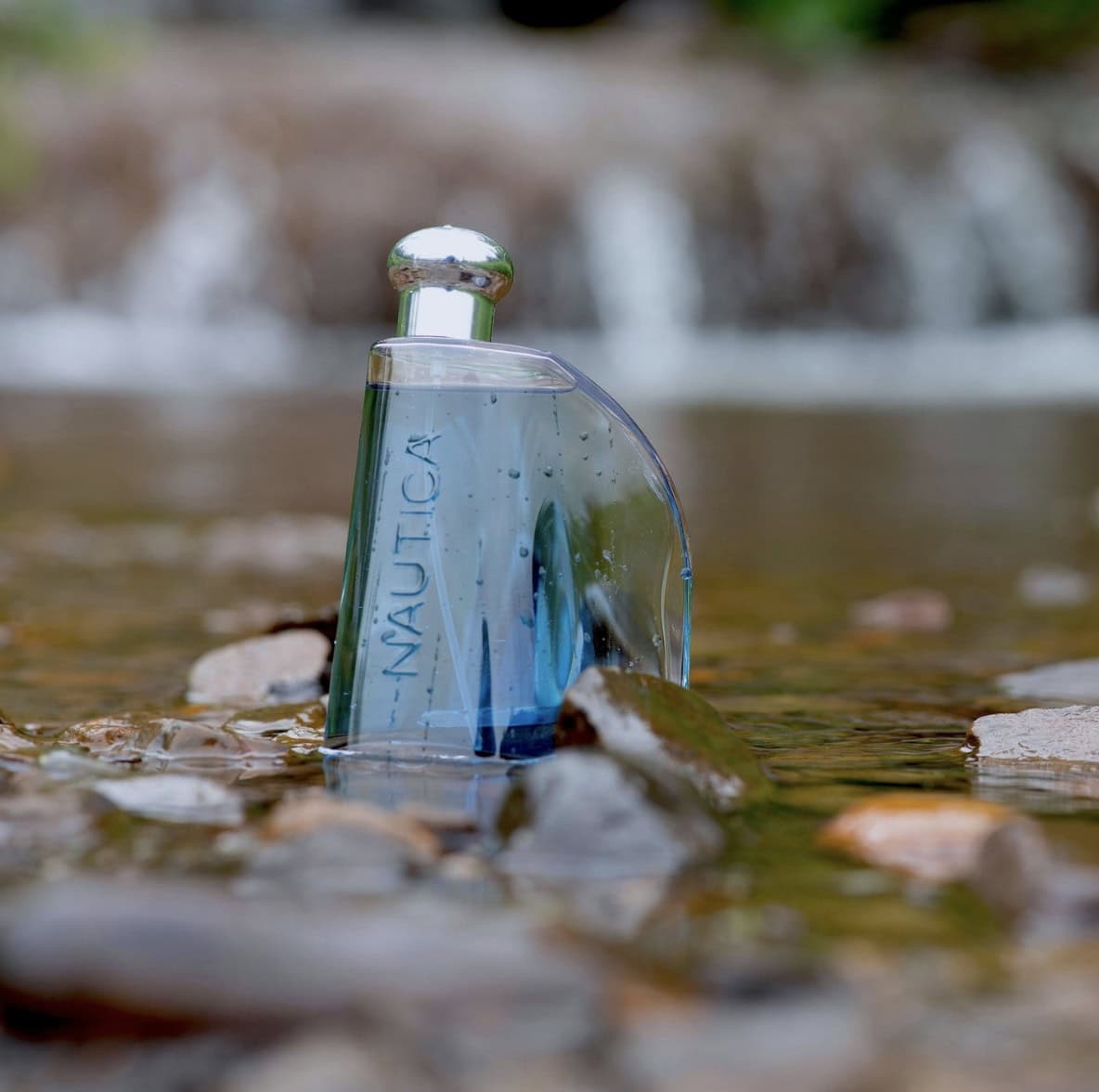 bottle of nautica cologne in a river bed