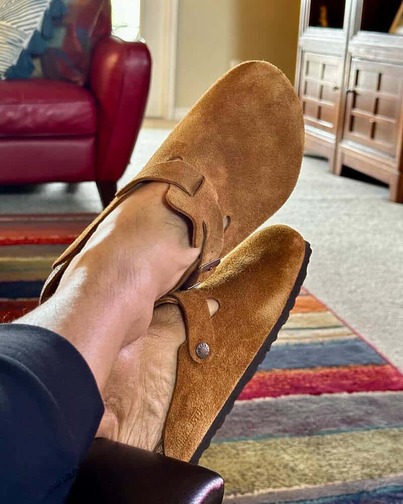 wearing a pair of brown Clogs by Crocs