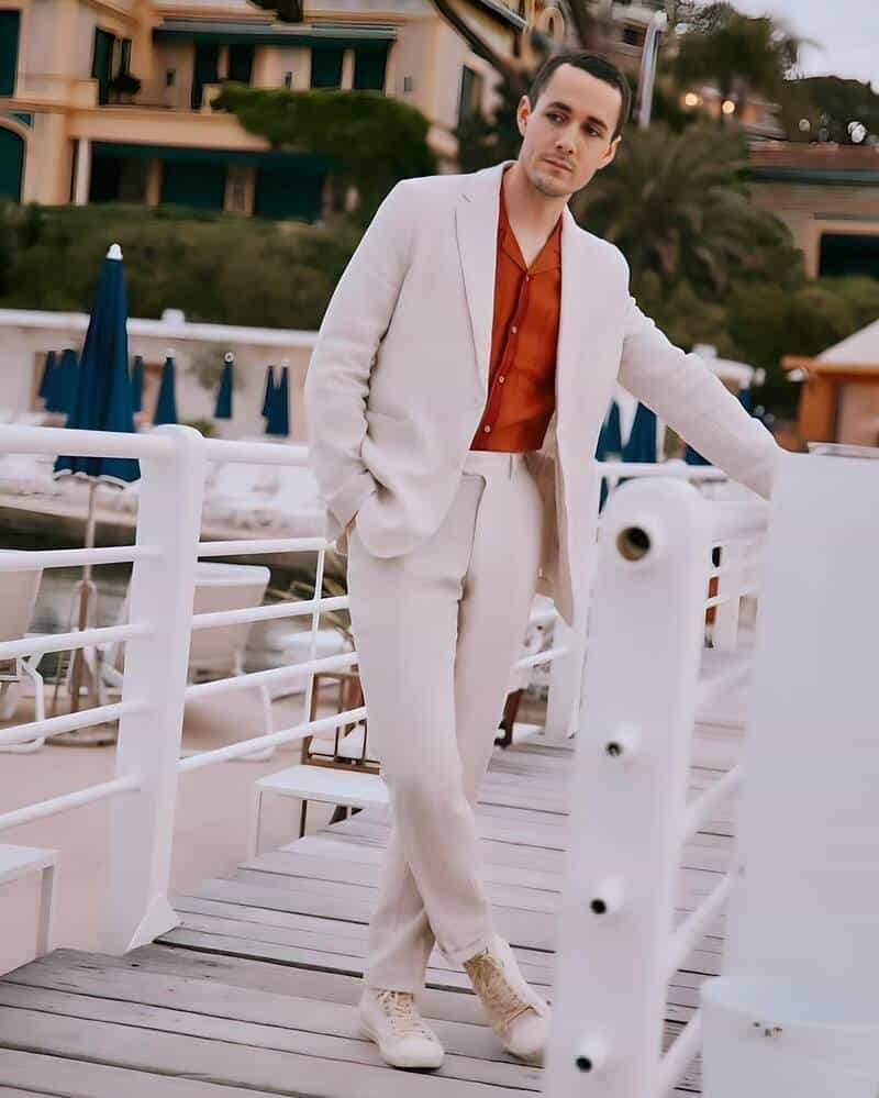 man wearing a knitted polo shirt under a suit