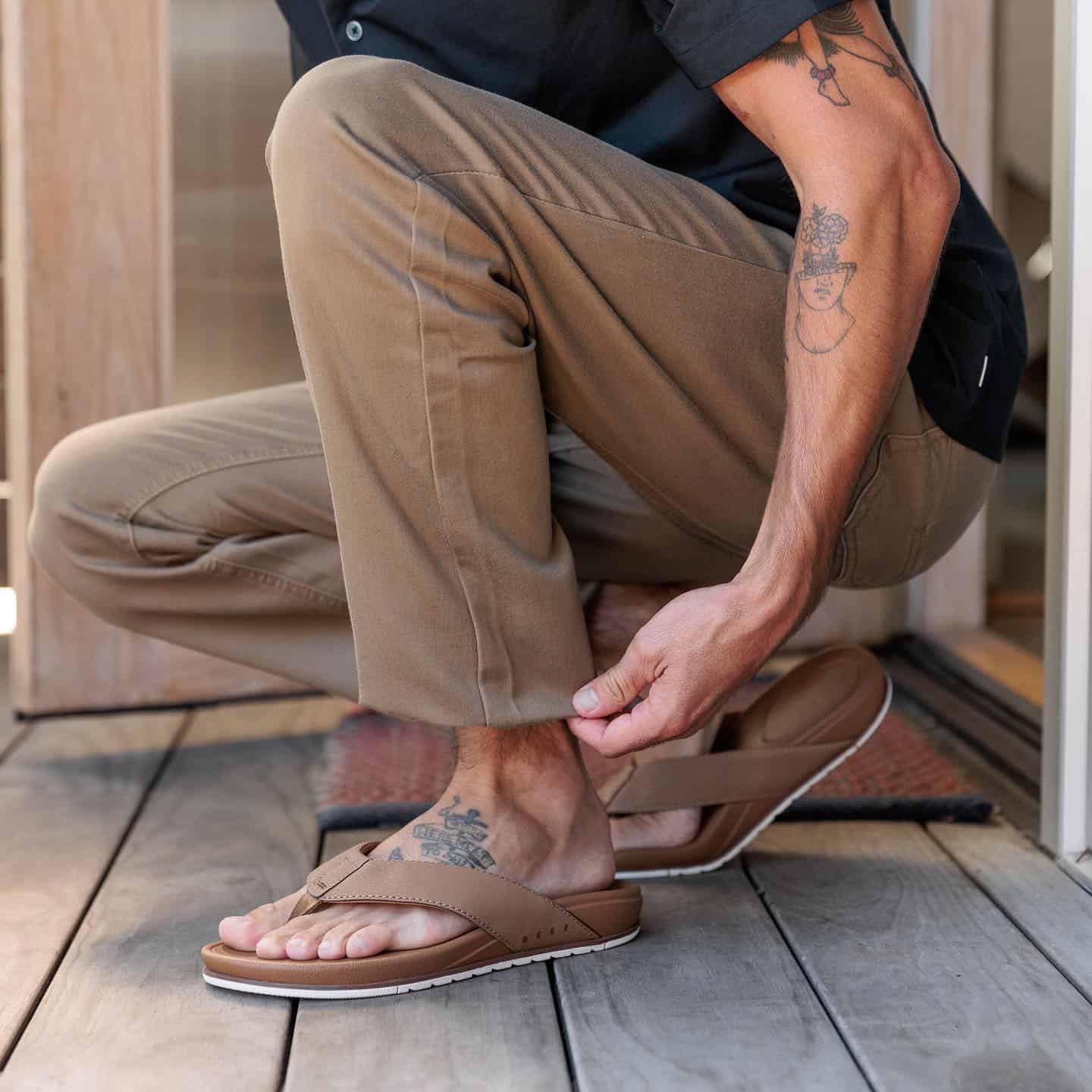 man folding the hem of his pants