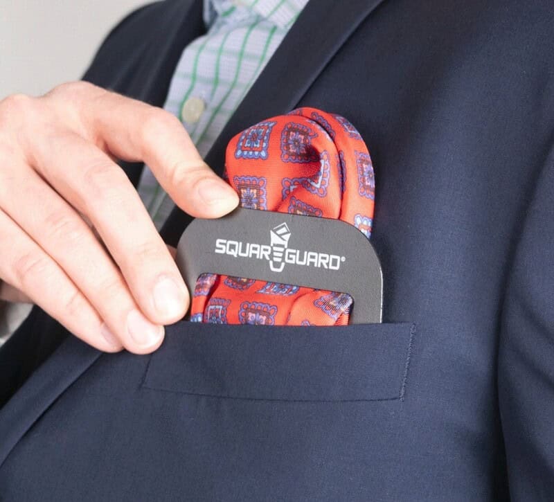 man using a square guard to hold a pocket square