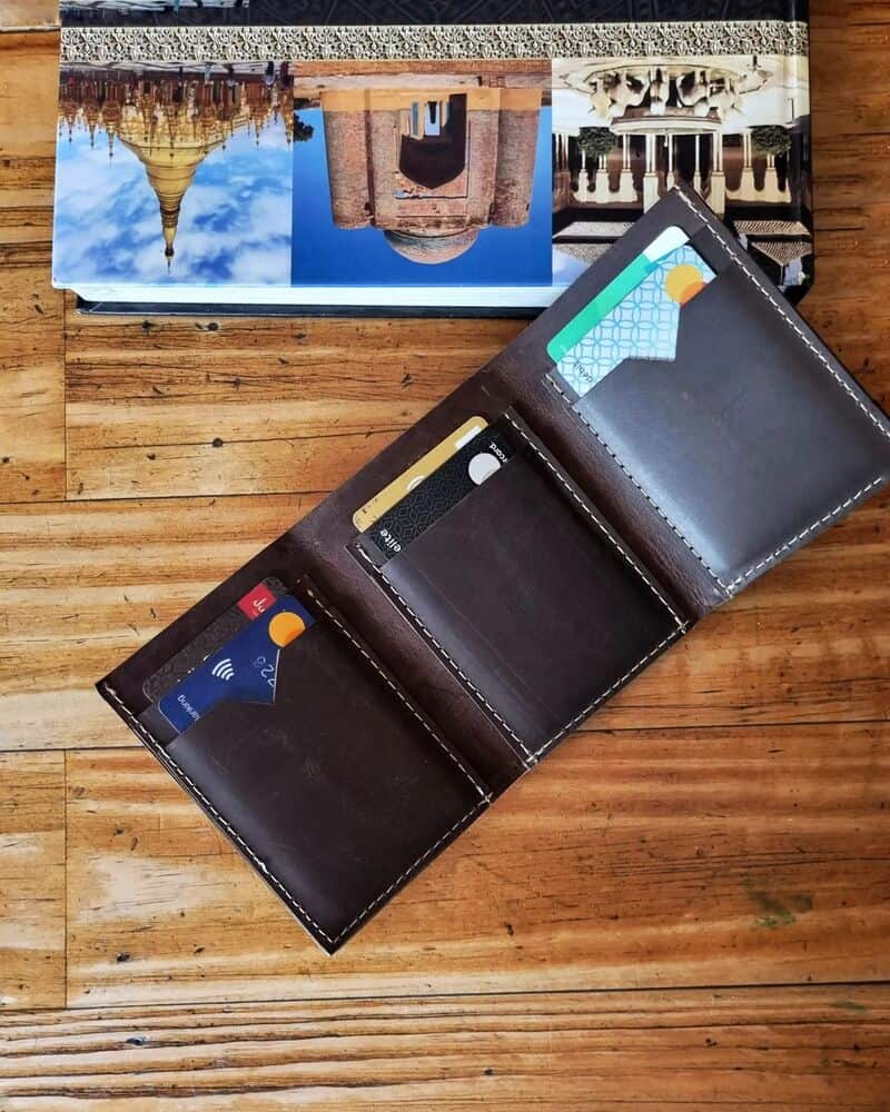 an open leather trifold wallet by snug