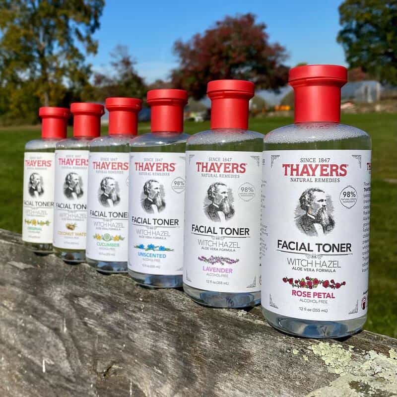 a collection of thayers facial toners lined-up on a wooden fence