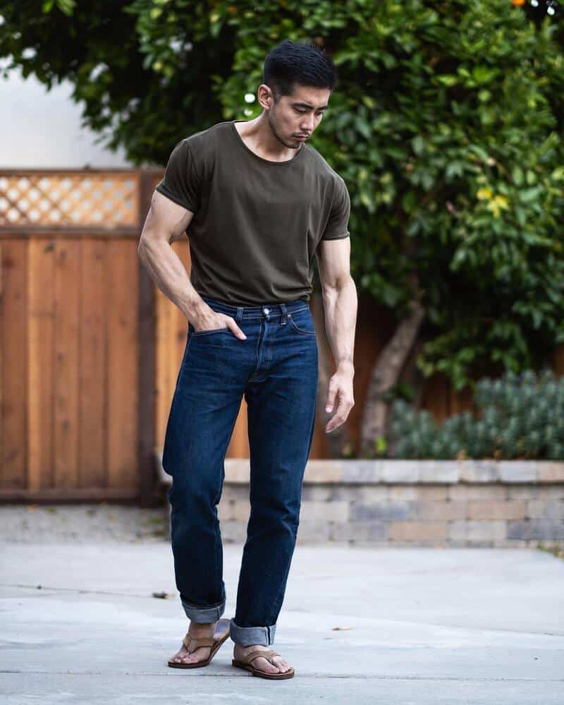 man wearing a t-shirt jeans and flip flops