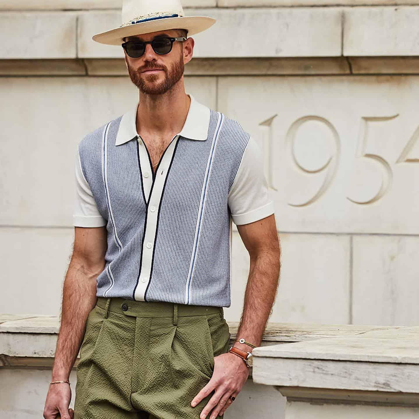 man in a hat wearing a knitted shirt