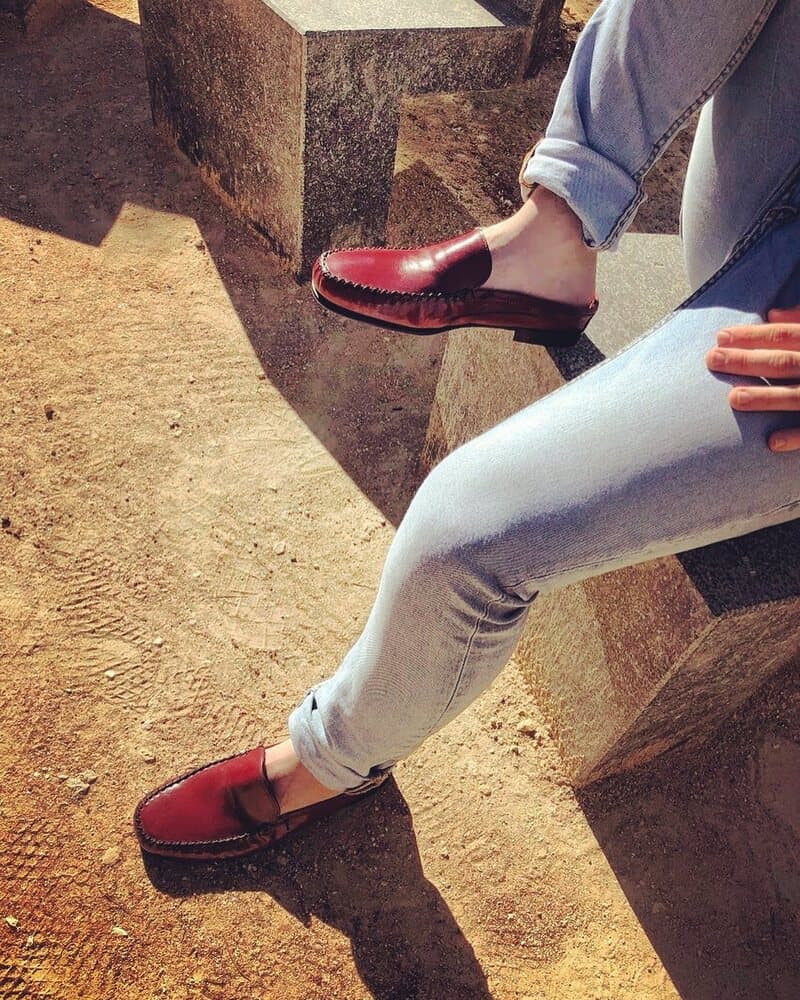 man wearing a pair of red leather mules