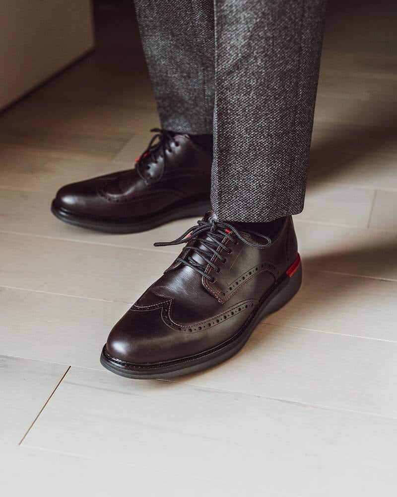 wearing a pair of wingtip oxfords by cole haan