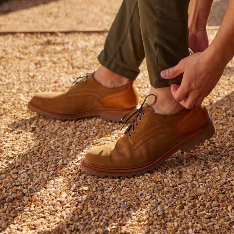 wearing a pair of brown derby by allen edmonds