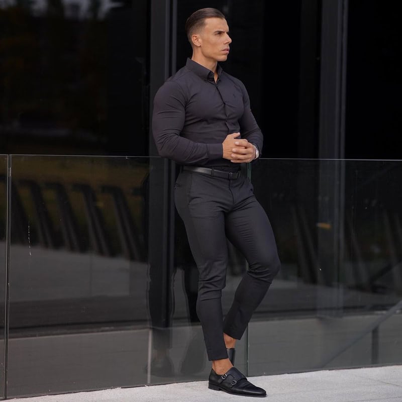 man in a fit black shirt and pants wearing a pair of black Monk strap shoes by Bruno Marc