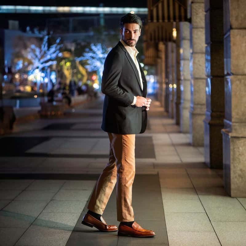 man in grey blazer and khaki pants wearing a pair of brown loafers by bruno marc