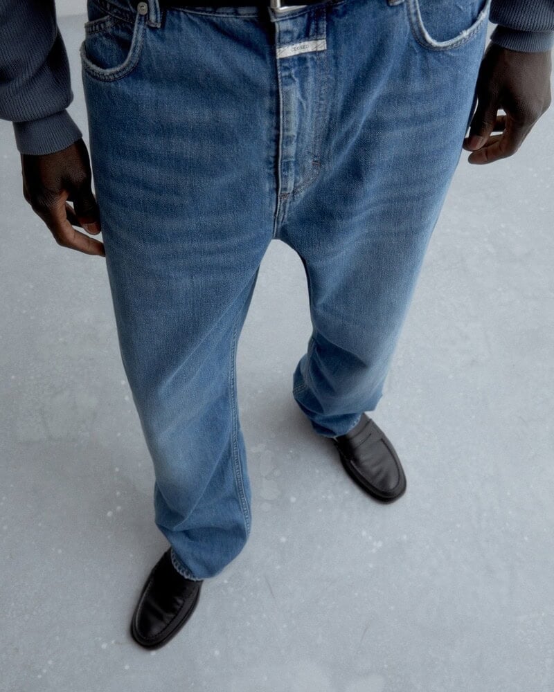 man wearing the slouchy jeans and classic loafers by closed