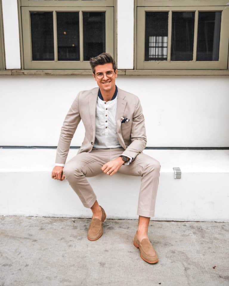man in a suit wearing a pair of cole haan venetian loafers