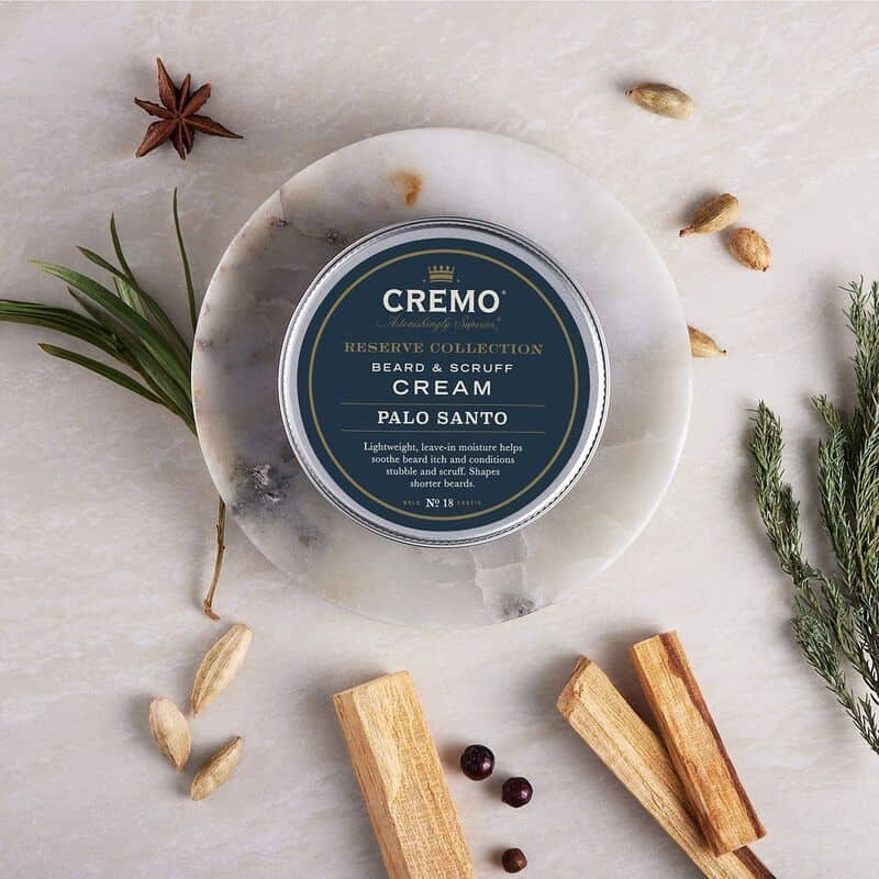 The Palo Santo Beard and Scruff Cream by Cremo on a small ceramic plate