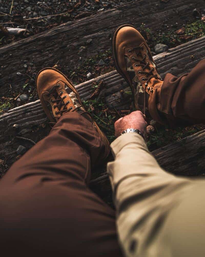 wearing a pair of camouflage boots by danner boots
