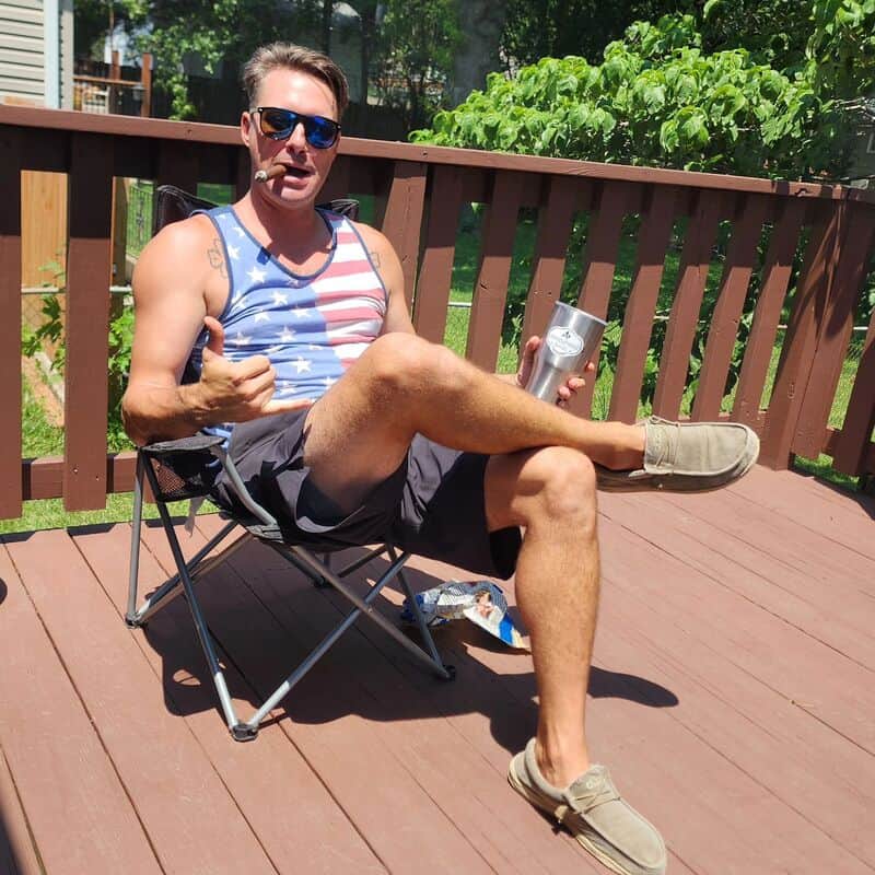 man on the patio enjoying his cigar