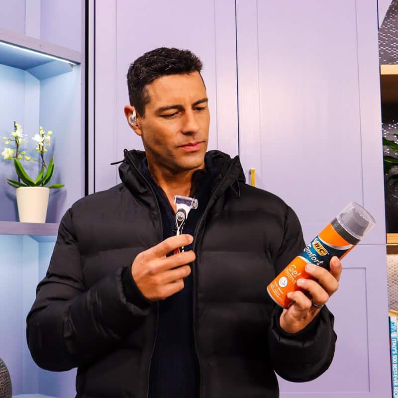 man holding a bic razor and bic shaving foam