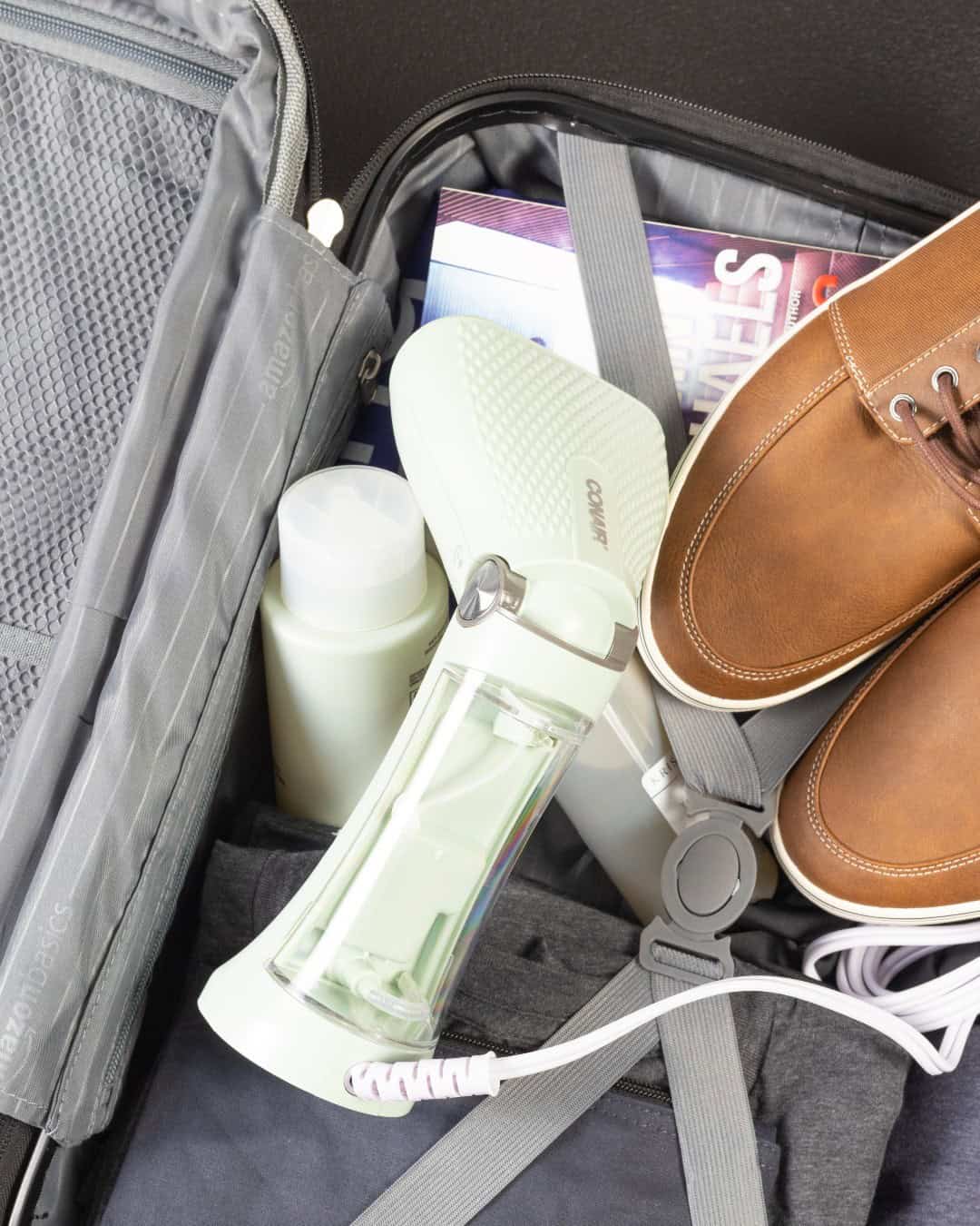 The Conair travel garment steamer inside a luggage