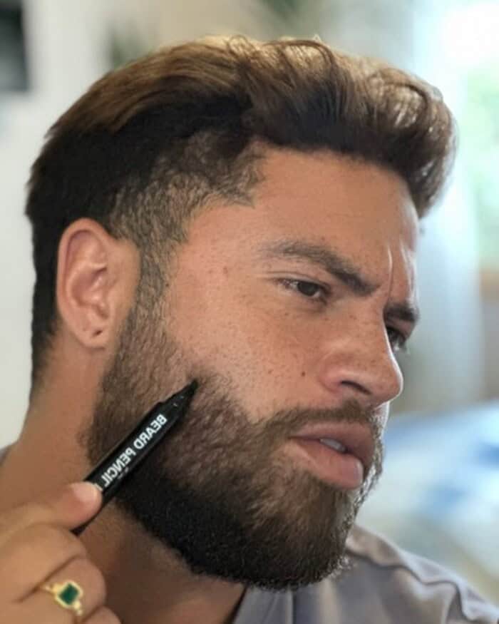 man patching gaps with the beard filler pen