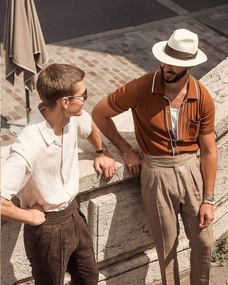 two men in pleated pants having a conversation