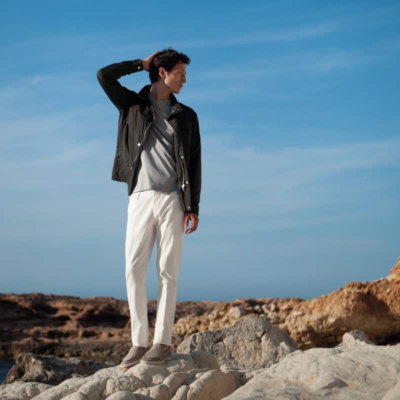 man standing on a rock wearing a pair of Yatch Loafers by Aurelien