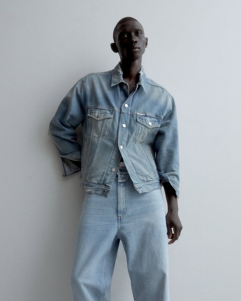 man wearin a denim jacket and light wash jeans