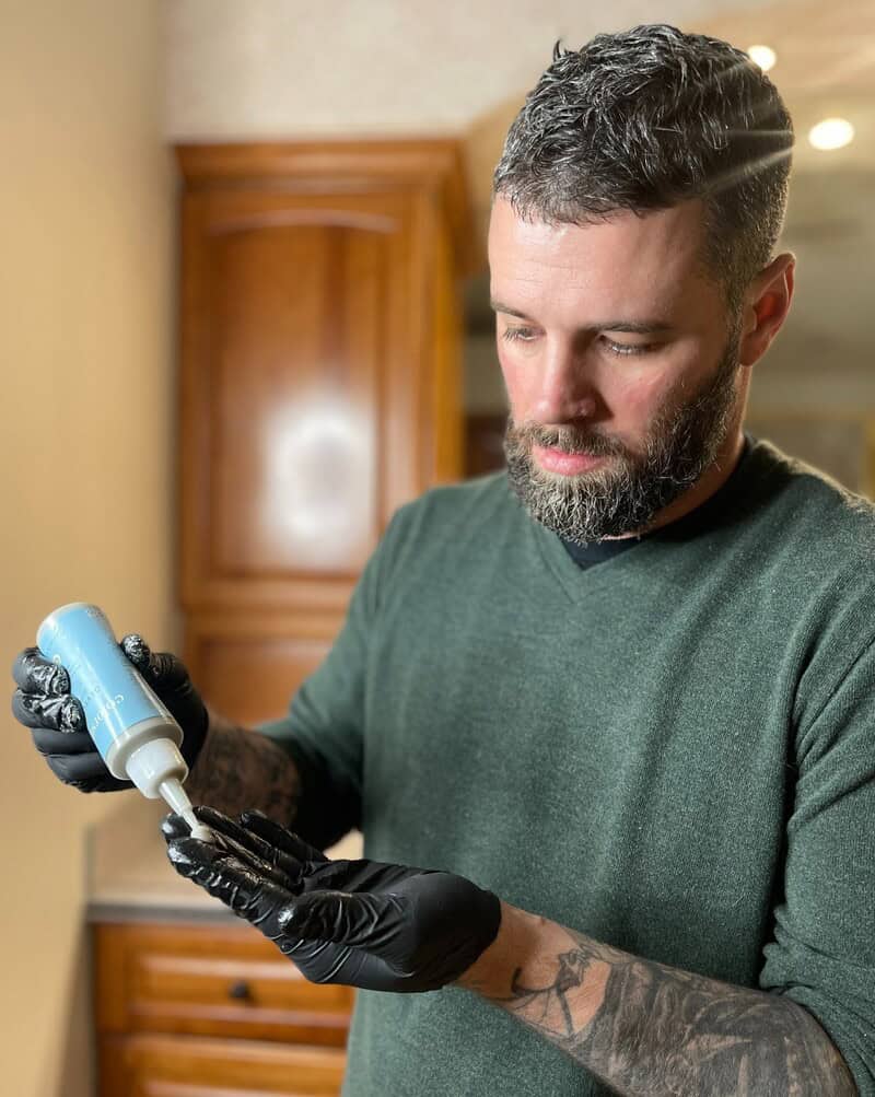 man preparing a hair dye mix