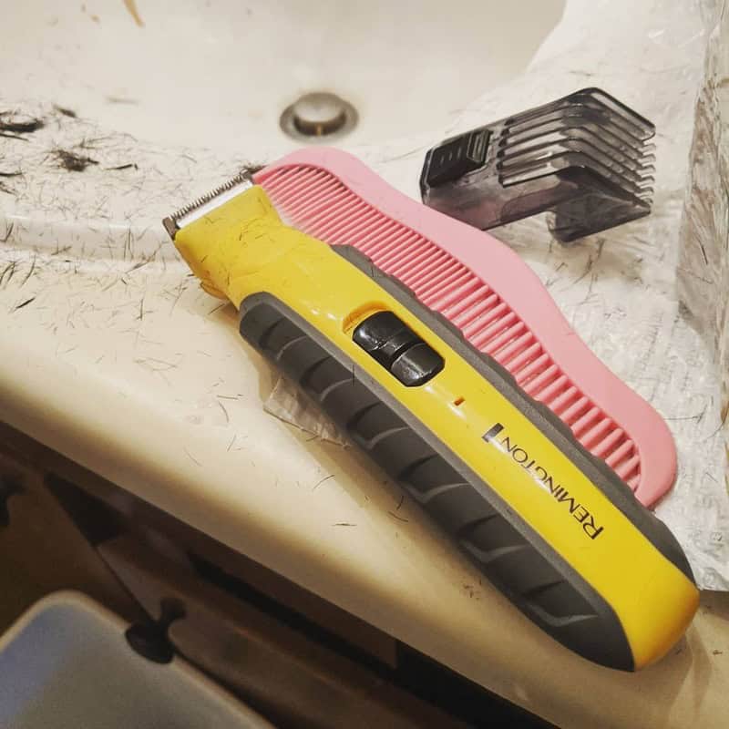 the Remington Virtually Indestructible All-in-One on a sink with comb