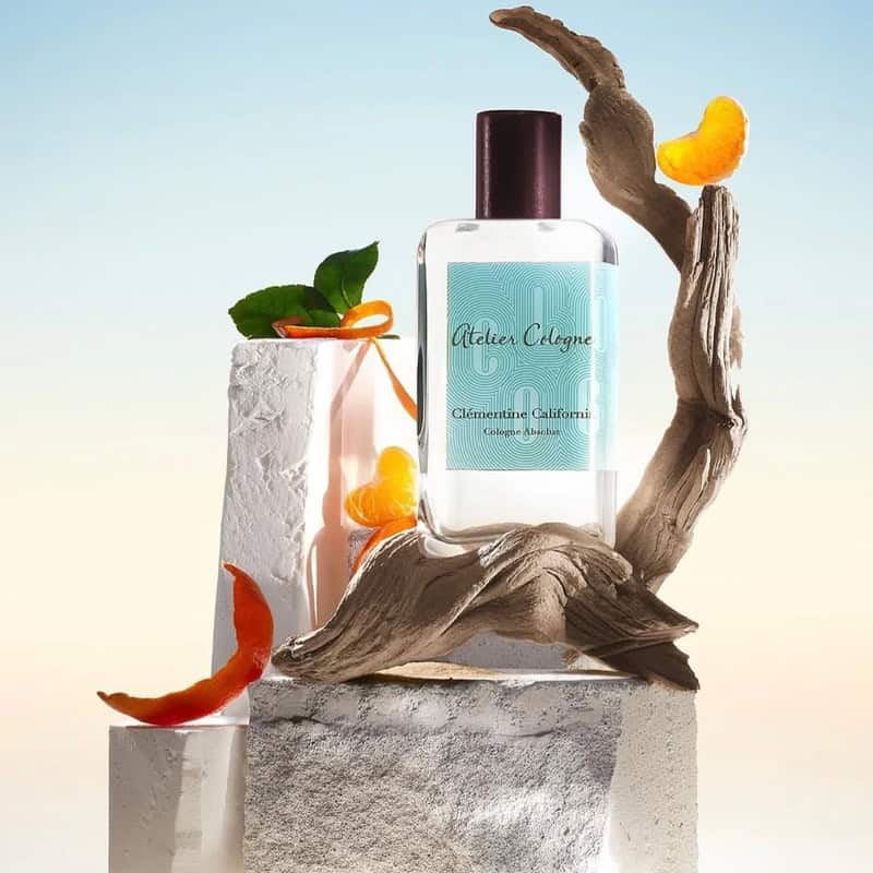 a bottle of Clementine California by Atelier Cologne on top of a dry piece of wood