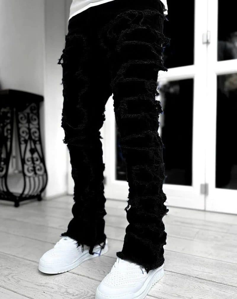 wearing a pair of patched stacked jeans