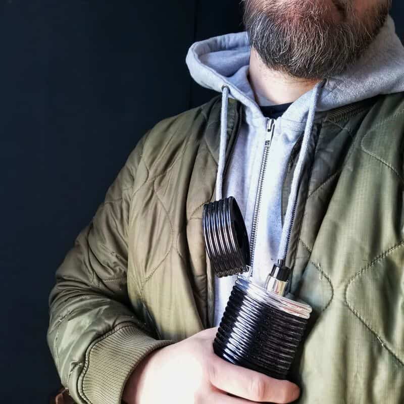 man holding a bottle of rasasi egra for men