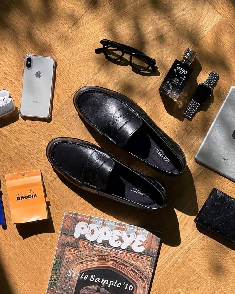 A pair of rockport loafers with everyday necessities