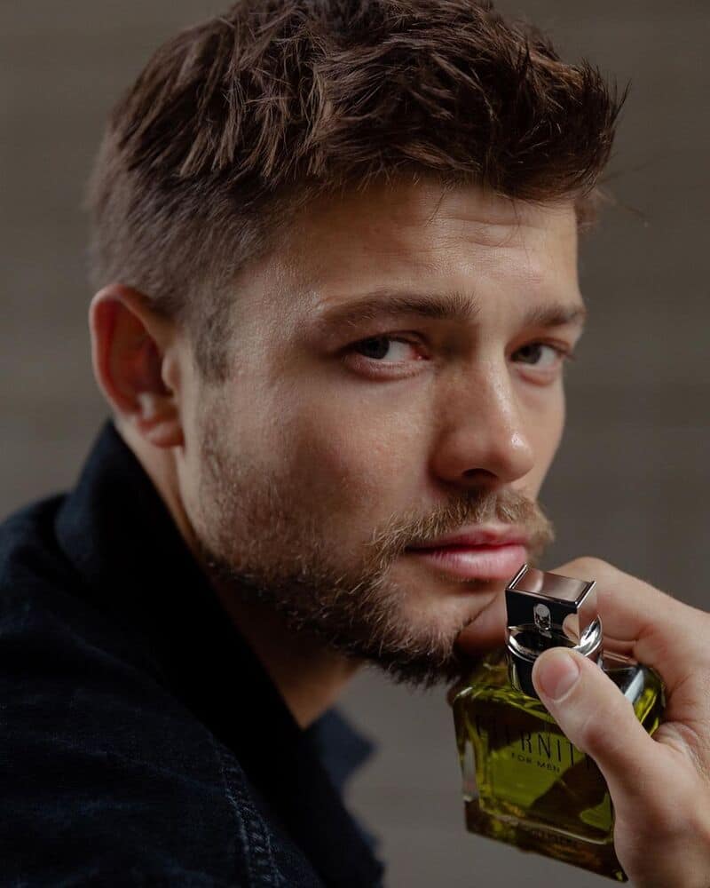 A man holding the calvin klein eternity cologne