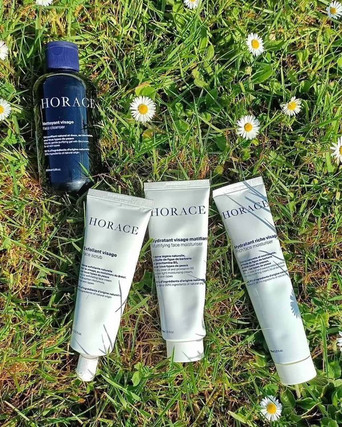 horace grooming products on the grass with small white flowers