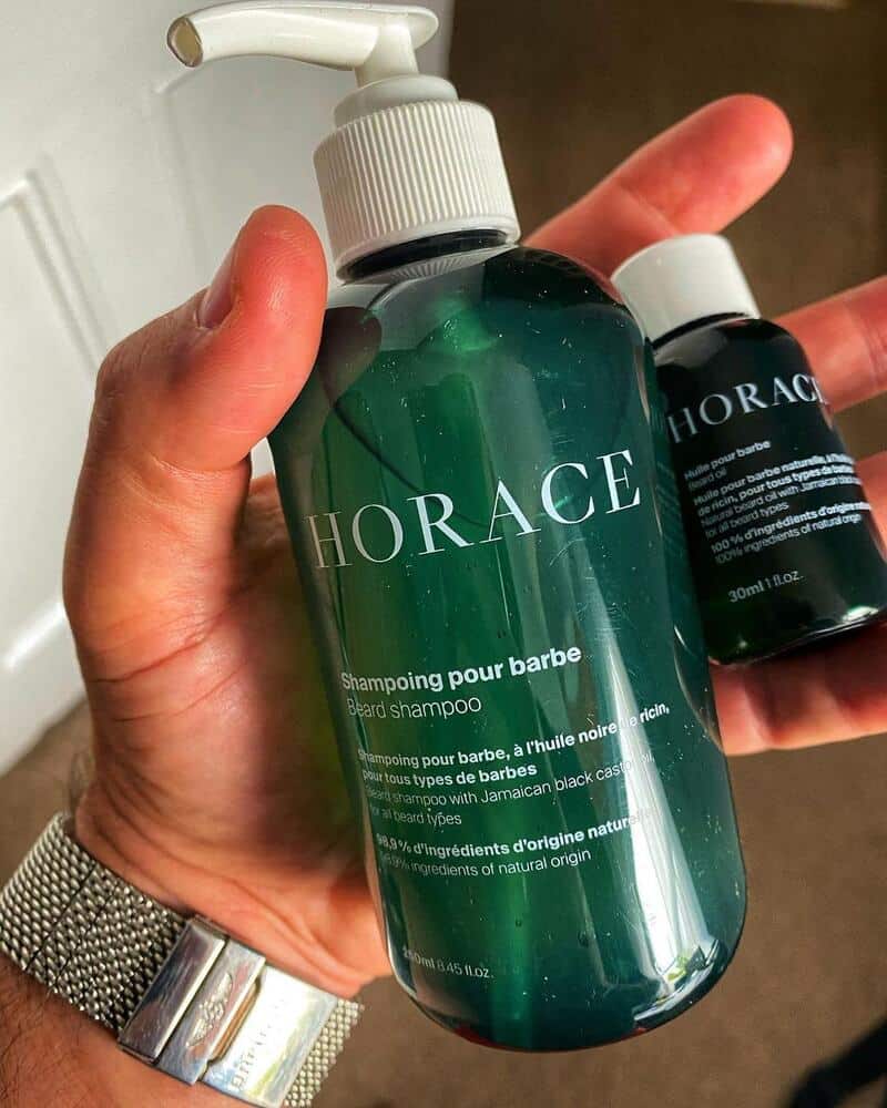 man holding a bottle of Beard Shampoo and Beard Oil