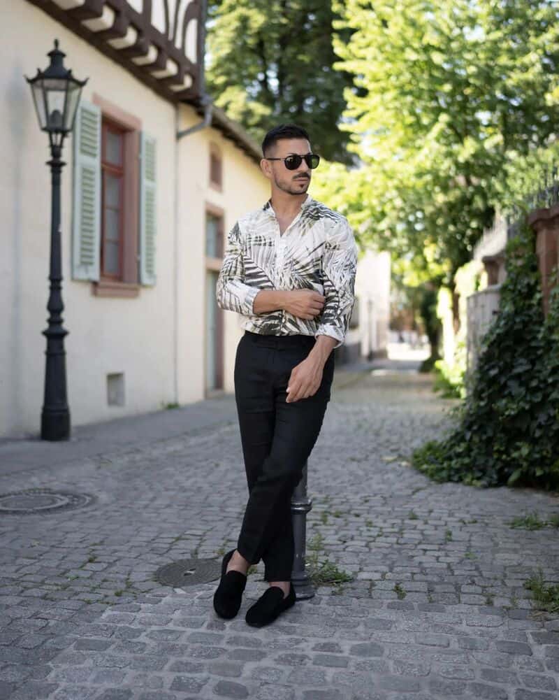 man wearing bruno march shoes with leaf printed shirt and black pants