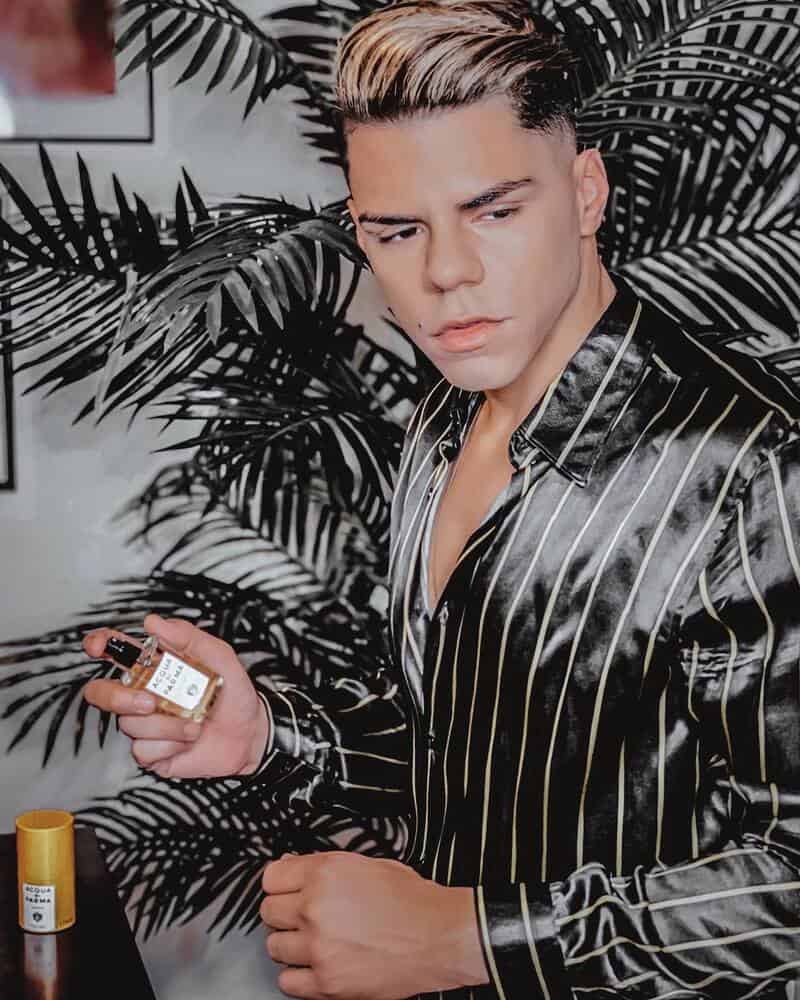 man holding a bottle of Acqua Di Parma Colonia Cologne