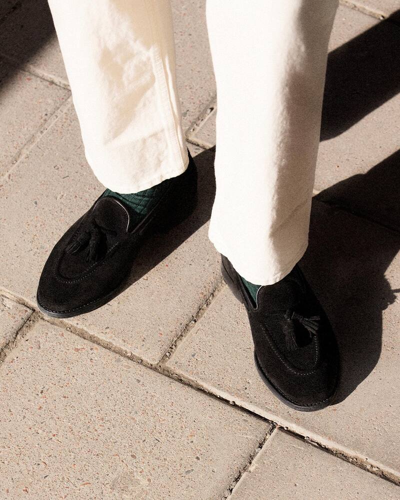 man wearing a pair of black suede tasseled loafers by Myrqvist