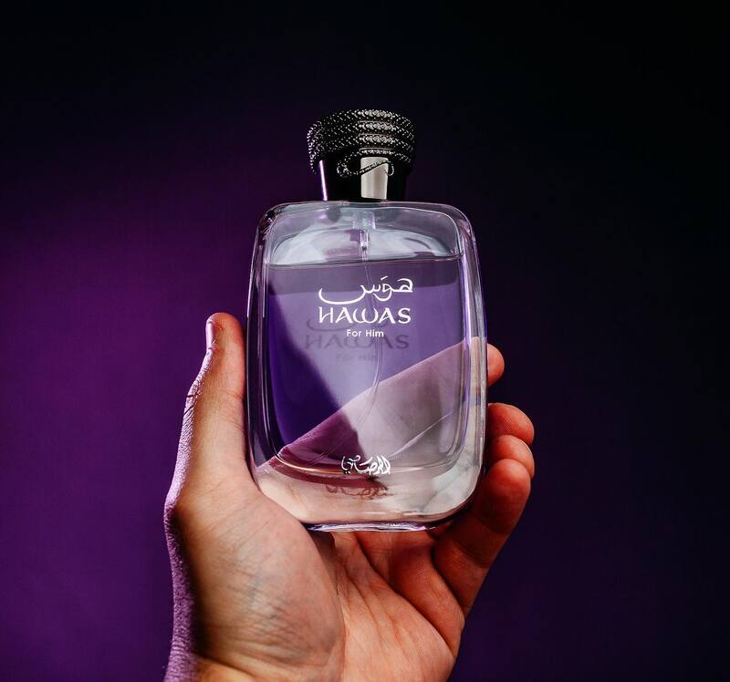 man's hand holding a bottle of hawas hor him cologne