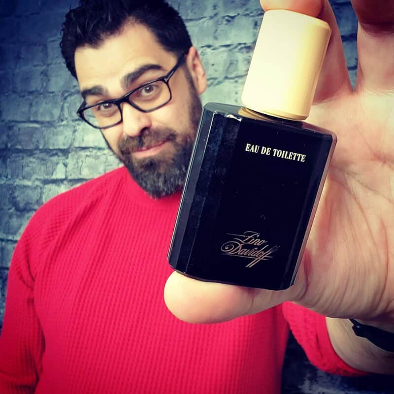 man holding a bottle of Fino Eau De Toilette by Davidoff